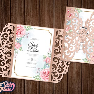 May include: A laser cut wedding invitation with a delicate floral design. The invitation features a pink and white floral pattern with a gold border. The text on the invitation reads "Sari and Datu".