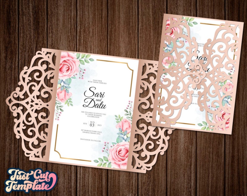 May include: A laser cut wedding invitation with a delicate floral design. The invitation features a pink and white floral pattern with a gold border. The text on the invitation reads "Sari and Datu".