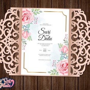May include: A laser cut wedding invitation with a delicate floral design. The invitation features a pink and white floral pattern with a gold border. The text on the invitation reads "Together with their families, Sari and Datu are pleased to invite you to celebrate their wedding. Sun, Jun 03, 2023, Het Margomojo Hall, Grabag Magelang. Invitation to follow."