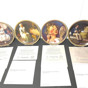 May include: Set of four decorative plates featuring Norman Rockwell paintings. The plates are gold rimmed and feature the following titles: "Waiting at the Dance", "Remembering in the Quest", "Making Believe at the Mirror", and "Pondering on the Porch".