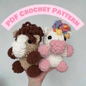 May include: Two crocheted stuffed animals, a brown and white horse and a white unicorn with a rainbow mane. The unicorn has pink cheeks and hooves. The horse has brown legs and a brown mane.  PDF CROCHET PATTERN.