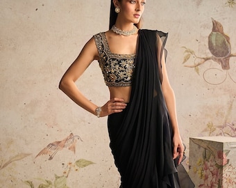 This combination of a black net blouse with gold handwork and a saree with an organza frill is likely to create a lovely and classic outfit.