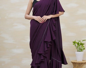 This Designer Outfit Pairs A Gorgeous Purple Ruffle Saree With A Stunning Black Sequin Blouse The Saree Features Artistic Frills And Pleats.