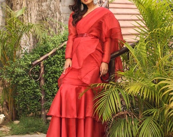 Organza Fabric Rust Red 2-layer Ruffle Lehenga Saree is a stunning ensemble that combines traditional elegance with contemporary flair.