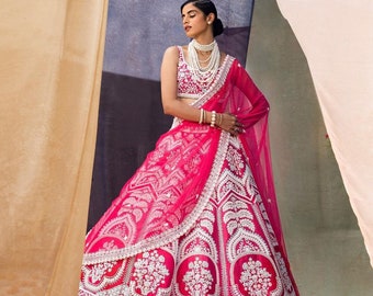 The Bridesmaids' pink lehenga choli with tapeta fabric and soft net coding dupatta is decorated heavily with embroidery and coding work.