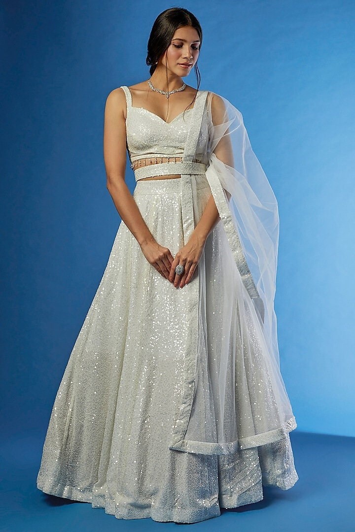 Designer white Georgette embroidered lehenga choli with a dupatta set featuring a handworked moti belt is an exquisite and elaborate ethnic.
