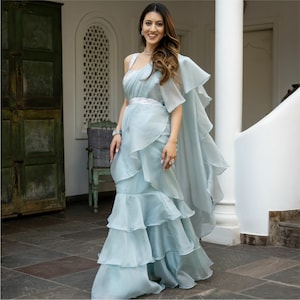 Blue ruffle sarees for wedding reception cocktail attire are designer-made wedding Indo-western clothes for women that are ready to wear.