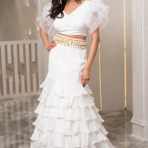 White Ruffle Lehenga Choli is a traditional outfit that includes white, ruffle choli worn at weddings, engagements, and other Occasions.