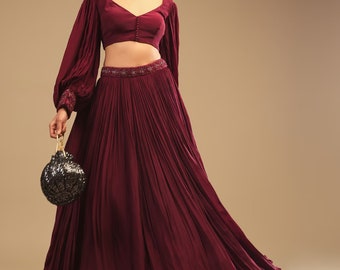 Designer this wonderful bishop-sleeve crop top and maroon lehenga will make you stand out in any crowd and wear in Weddings and Engagements.