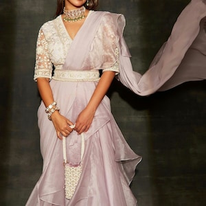 Designer handwork net blouse with an organza pre-draped saree paired with a handwork belt is a stylish and contemporary take on traditional.