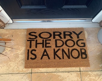 Dog is a Knob personalised door mat. No silhouette just the writing. Hand painted. Makes the perfect funny present
