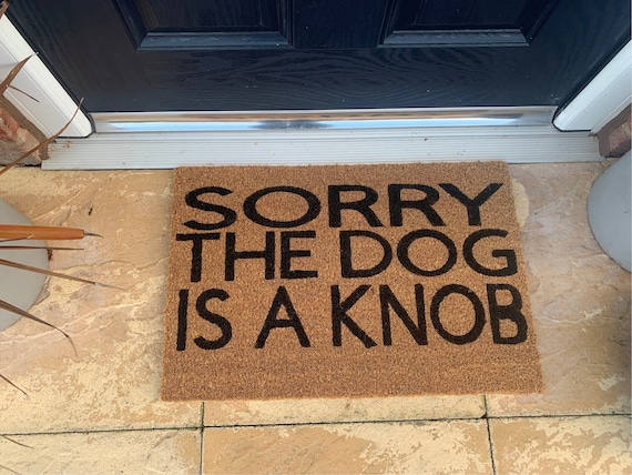 Dog is a Knob personalised door mat. No silhouette just the writing. Hand painted. Makes the perfect funny present