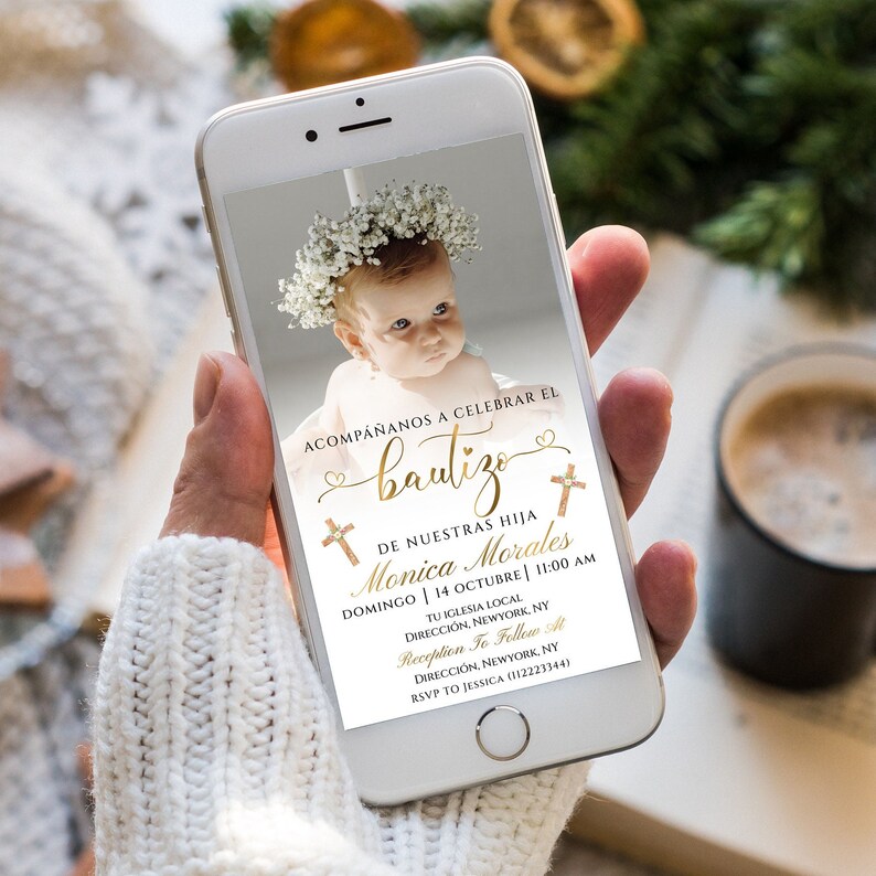 May include: A digital invitation for a baby's baptism. The invitation features a photo of a baby girl wearing a white dress and a flower crown. The text on the invitation reads "Acompa&ntilde;anos a celebrar el bautizo de nuestras hija Monica Morales Domingo 14 Octubre | 11:00 AM Tu Iglesia Local Direcci&oacute;n, Newyork, NY Recepci&oacute;n To Follow At Direcci&oacute;n, Newyork, NY RSVP to Jessica (112223344)"