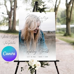 May include: A white sign with a black easel, a floral arrangement, and a photo of a woman. The sign reads "Celebrating The Life Of Ashley Smith OCT 18. 1962 - MARC 5. 2018".