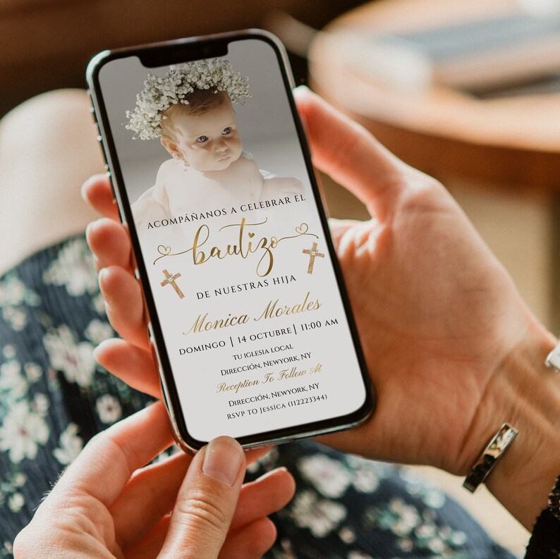 May include: A digital invitation for a baptism with a photo of a baby girl wearing a flower crown. The invitation is in Spanish and includes the baby's name, Monica Morales, the date and time of the baptism, and the location of the church and reception. The text reads "Acomp&aacute;&ntilde;anos a celebrar el bautizo de nuestras hija Monica Morales Domingo | 14 Octubre | 11:00 AM Tu Iglesia Local Direcci&oacute;n, Newyork, NY Reception To Follow At Direcci&oacute;n, Newyork, NY RSVP to Jessica (112223344)"