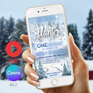 May include: A blue and white winter wonderland themed digital invitation for a first birthday party. The invitation features a snowflake design with the text "Join us in a Winter Wonderland to celebrate Ashley's 1st Birthday". The invitation also includes the date, time, and location of the party.