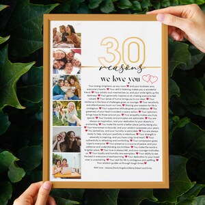 May include: A framed print with a collage of photos and the text "30 reasons we love you" in gold lettering. The text is surrounded by red hearts.