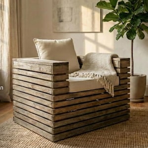 May include: A rustic wooden armchair with a light-colored cushion and pillow. A beige throw blanket with fringe is draped over the seat. The chair is made of horizontal wooden planks. The image also includes text: DIY Woodworking Plan, Beginner Friendly, and 5-8 Hours Build Time.