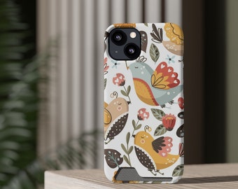 May include: A white iPhone case with a colorful floral and bird design. The case features a variety of birds, flowers, and leaves in shades of blue, yellow, green, and pink.