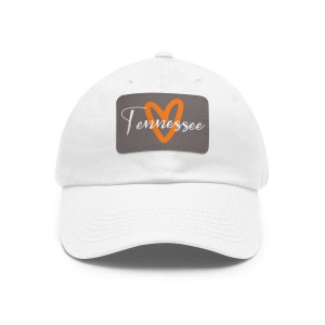 May include: White baseball cap with a grey patch featuring an orange heart and the text "Tennessee".