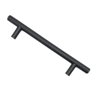 May include: A matte black cabinet pull with a cylindrical bar and two perpendicular handles. The hardware is designed for easy installation and adds a modern touch to furniture. The pull measures approximately 8 inches in length.