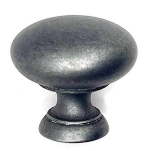 May include: A close-up of a gray, oval-shaped cabinet knob. The knob has a textured surface and a stem with a decorative base. The hardware is made of metal and is set against a white background.