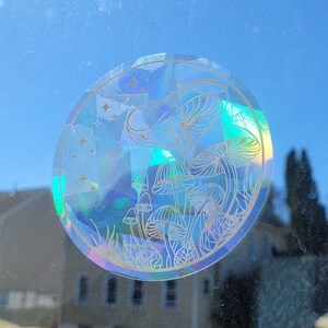 Puede incluir: Una pegatina hologr&aacute;fica con un contorno blanco de setas y estrellas sobre un fondo azul.