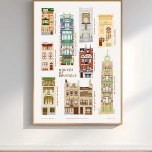 May include: A framed print showcasing detailed illustrations of Brussels houses. The artwork includes the text "HOUSES OF BRUSSELS" and building names. The print is displayed on a white wall above a wooden floor, with a gold-colored frame.