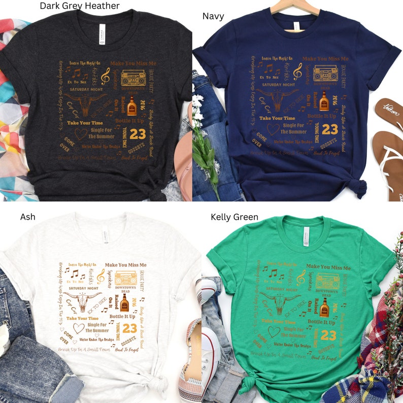 K&ouml;nnte beinhalten: Vier T-Shirts in Dunkelgrau-Melange, Marine, Asch und Kelly Green. Jedes Shirt hat ein grafisches Design mit Text, einem Bullenkopf, einer Boombox und der Zahl 23. Die Shirts sind Freizeitkleidung.