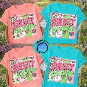May include: Four short-sleeved t-shirts in coral and turquoise, each with a watermelon-themed graphic. The text on the shirts reads "Sweet Mama Life" and "Sweet Gigi Life" in pink and green. The shirts are displayed on a wicker basket.
