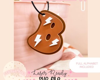 May include: A brown lightning bolt initial tag with a white lightning bolt design. The tag is hanging from a black string. The text "LIGHTNING INITIAL TAG" is at the top of the image. The text "FULL ALPHABET INCLUDED" is at the bottom of the image. The text "Laser Ready eeee SVG FILE eeee" is in the center of the image.