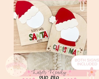 May include: Two wooden Christmas countdown signs. Each sign features a Santa hat, a white circle, and text. One sign says "SLEEPS UNTIL SANTA VISITS" and the other says "DAYS UNTIL CHRISTMAS". The text "Laser Ready SVG file" is also visible.