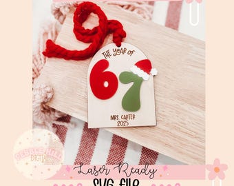 May include: A wooden Christmas ornament with the text "SIX SEVEN ORNAMENT". The ornament features the numbers "67" in red and green, with a Santa hat on the "7". The text "THE YEAR OF", "MRS. CARTER 2025" and "Laser Ready SVG file" are also visible.