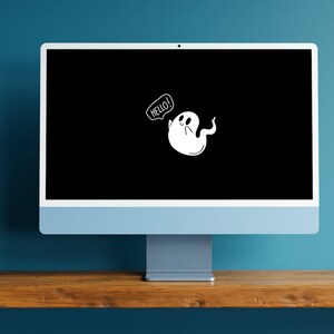 May include: A computer monitor with a black screen displaying a white cartoon ghost with a speech bubble that says "hello!"