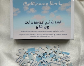 May include: A blue and white jigsaw puzzle with a sky background. The puzzle pieces have Arabic text and the English translation, "all praise belongs to Allah who has restored us back to life after causing us to die; and to Him shall we return." The puzzle is titled "My Morning Dua."