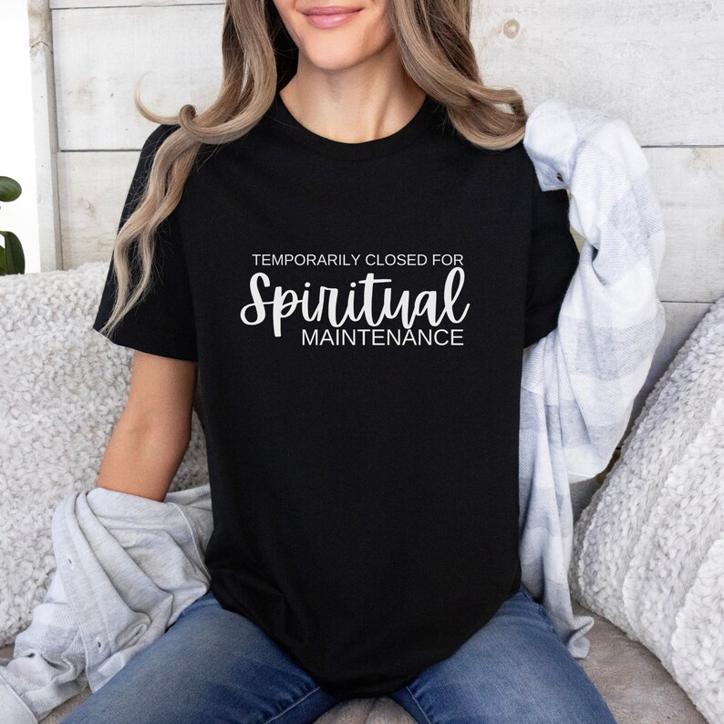 May include: A black t-shirt with white text that reads "Temporarily Closed for Spiritual Maintenance".