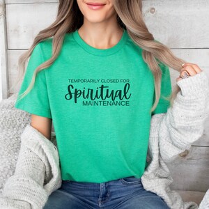 May include: A green t-shirt with the text "Temporarily Closed for Spiritual Maintenance" in black.