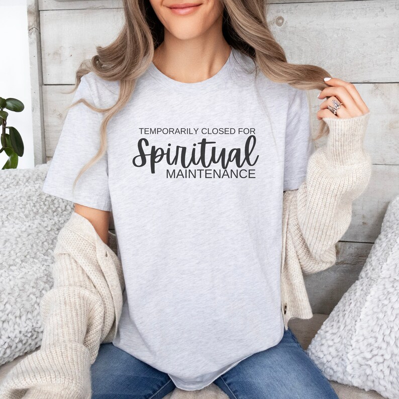 May include: A gray t-shirt with the text "Temporarily Closed for Spiritual Maintenance" in black.