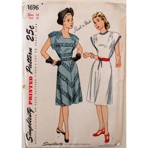 May include: Vintage Simplicity sewing pattern 1696 for a dress. The pattern is printed on a white paper background with a black and red border. The pattern includes two dress designs, one with a blue and white print and the other with a white fabric. The pattern is for size 14, bust 32, and costs 25 cents.