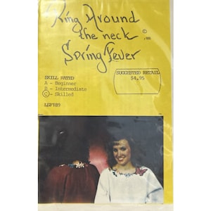 May include: A yellow paper pattern envelope with a photo of two people wearing embroidered shirts. The text on the envelope reads "Ring Around the Neck Spring Fever" and "Skill Rated: C - Skilled" and "Suggested Retail $4.95".