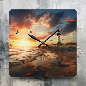 May include: A square clock with a sunset and lighthouse scene. The clock face is black with white hands. The background shows a lighthouse on a rocky shore with a sunset over the ocean.