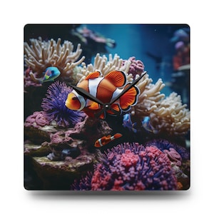 May include: A clock with an orange and white clownfish swimming in a coral reef. The clock hands are black and the background is blue.