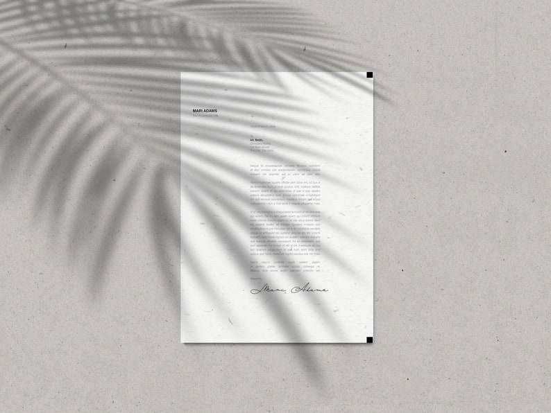 May include: A white letterhead with the name "Mari Adams" at the top, featuring a handwritten signature at the bottom. The paper is textured and has a shadow of a palm leaf across it. The background is a light gray.