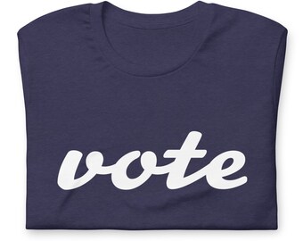 May include: A navy blue t-shirt with the word "vote" printed in white cursive lettering.