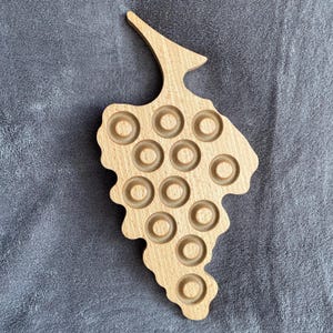 Champagne bottle cap display with grape clusters