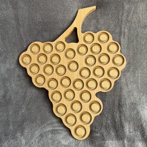 Champagne bottle cap display with grape clusters