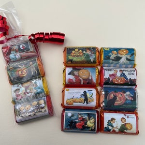 May include: A set of 10 individually wrapped Halloween-themed chocolate bars. Each bar features a vintage illustration of children, pumpkins, and cats. The wrappers are decorated with red, orange, and yellow colors.