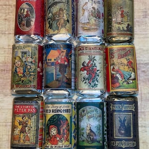 Pode incluir: Uma coleção de barras de chocolate em estilo vintage com designs de capas de livros. Os títulos incluem "Branca de Neve e Rosa Vermelha", "Polegarzinha", "Alice no País das Maravilhas" e "A História de Peter Pan".
