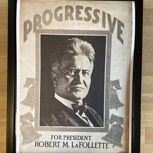 May include: A vintage political poster featuring a black and white portrait of Robert M. La Follette, a candidate for president. The poster has the word "PROGRESSIVE" in large, bold letters at the top and the text "FOR PRESIDENT ROBERT M. LA FOLLETTE" at the bottom. The poster is framed in black.
