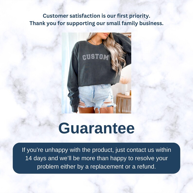 May include: A dark gray cropped sweatshirt with the word "CUSTOM" printed on the front. The sweatshirt is being worn by a person with long blonde hair and is paired with light blue denim shorts. The image has a white marble background with the text "Guarantee" and a message about a 14-day return policy.